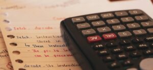 Tax planning documents and calculator showing federal tax deduction calculations for 2025 One Big Beautiful Bill Act benefits